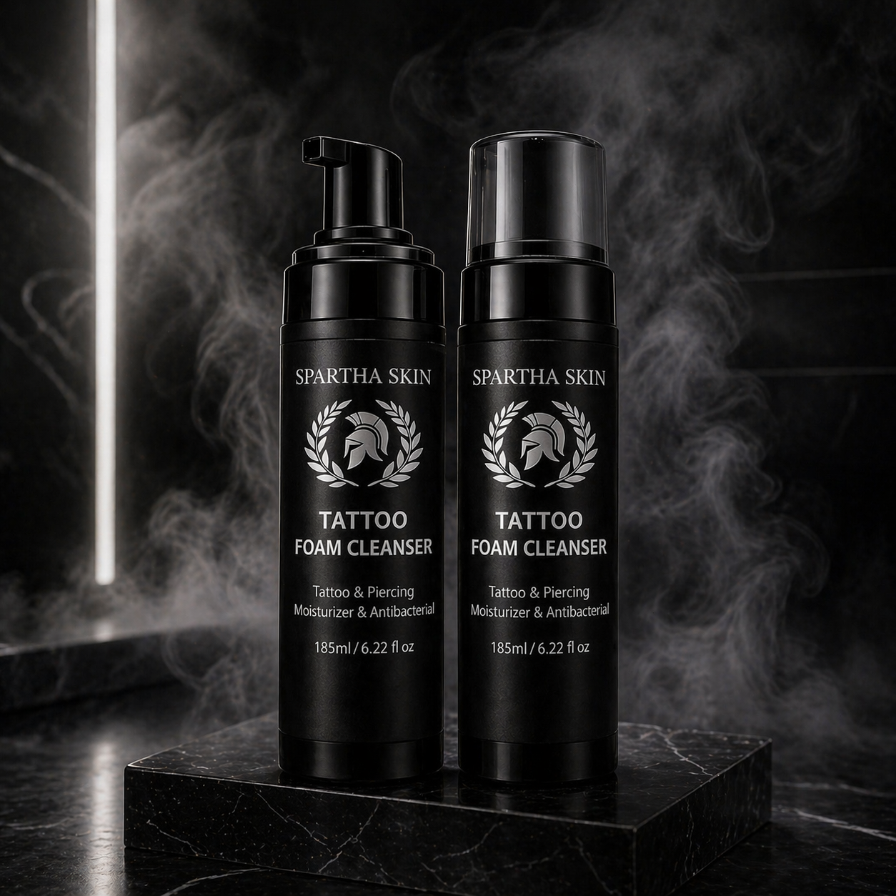 Two Spartha Skin Tattoo Foam Cleanser bottles on black background with smoke